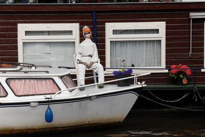 Man standing on boat against building