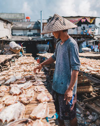 Midsection of man standing at market stall