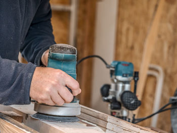 Midsection of man working at workshop