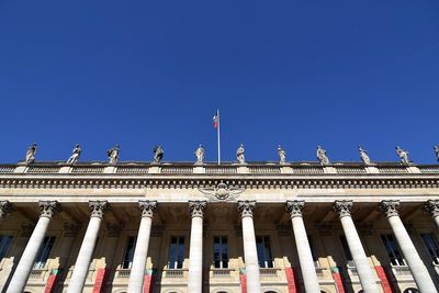 Low angle view of sculptures on grand theater de bordeaux against clear sky