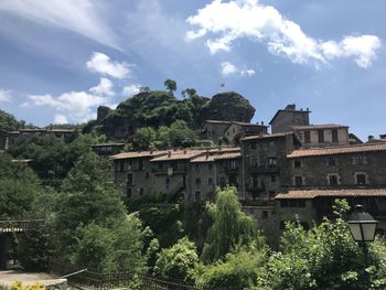 Trees and buildings against sky