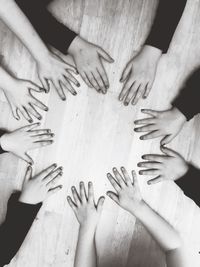 Cropped image of hands on hardwood floor