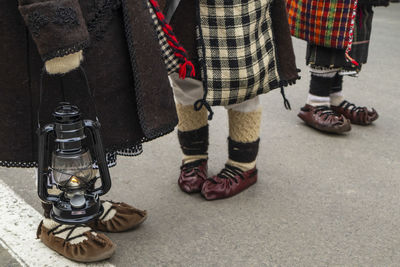 People in traditional clothing standing on street