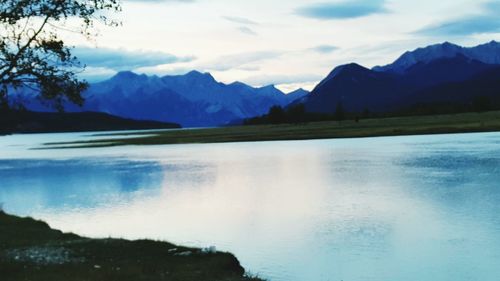 Scenic view of lake and mountains against sky