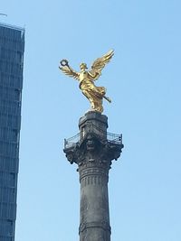 Low angle view of statue against clear blue sky