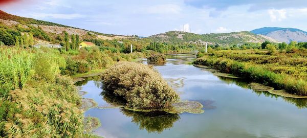 Scenic view of lake and mountains against sky