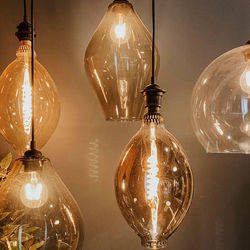 Illuminated light bulbs hanging from ceiling