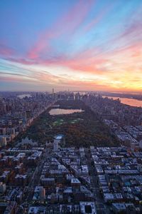 Aerial view of cityscape against sky during sunset