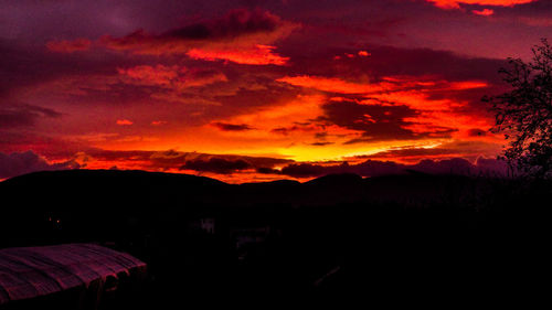 Scenic view of silhouette mountains against sky at sunset