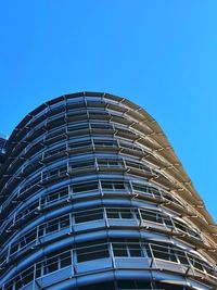 Low angle view of modern building against clear blue sky