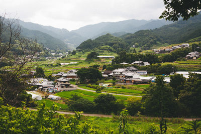 Houses on hills against sky