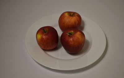 High angle view of apples in plate on table