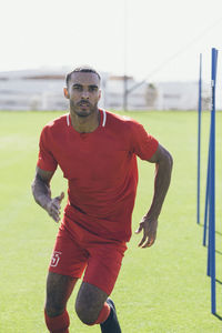 Upper part of male african american soccer player practicing at pitch