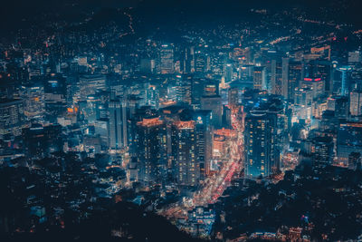 High angle view of illuminated buildings in city at night