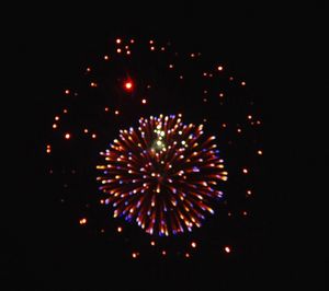 Low angle view of firework display at night