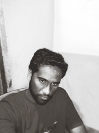 Portrait of young man sitting at home