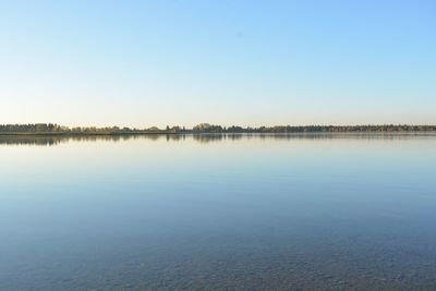 Scenic view of lake against clear blue sky