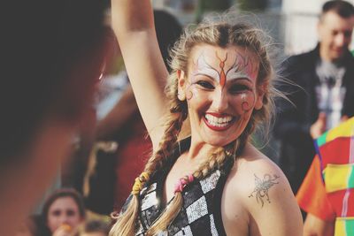 Portrait of smiling woman with face paint 