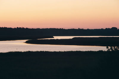 Scenic view of lake against sky during sunset