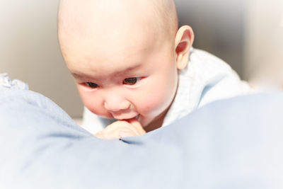 Close-up of baby boy on bed