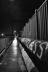 Empty footpath in illuminated building at night