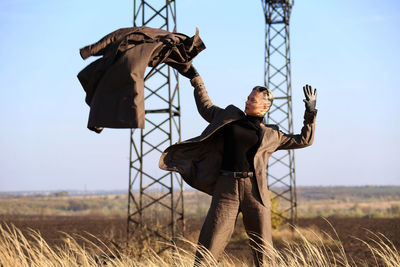 Woman standing on field against sky