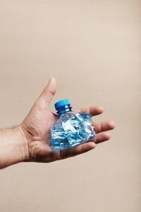 Close-up of hands holding plastic bottle