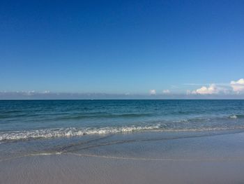 Scenic view of sea against blue sky