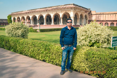 Portrait of smiling man standing against built structure