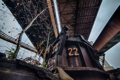 Low angle view of abandoned building against sky
