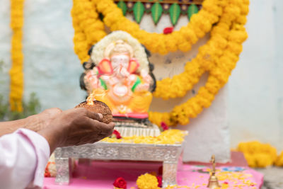 Close-up of hand holding candles in temple