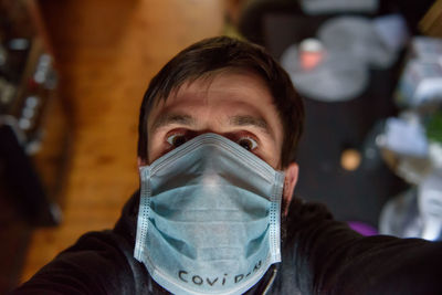 Close-up portrait of man wearing mask