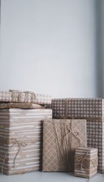 Stack of basket on table against wall at home