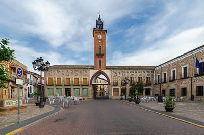 Street amidst buildings in city against sky