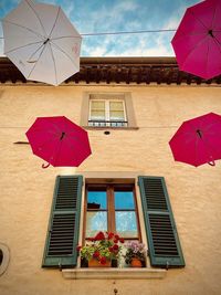 Low angle view of window thith umbrellas