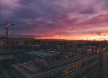 High angle view of buildings in city against sky during sunset