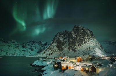 Scenic view of snowcapped mountains against sky at night during winter