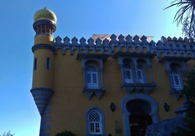 Low angle view of building against blue sky