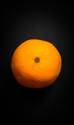 High angle view of orange slices over black background