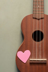 Close-up of heart shape on guitar at table