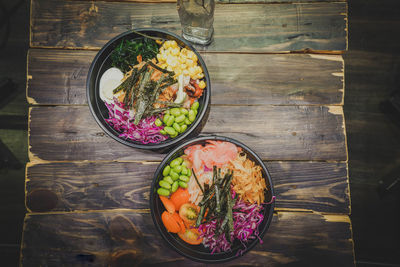 High angle view of salad in bowl on wooden table