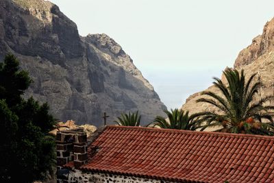 Houses on mountain against clear sky