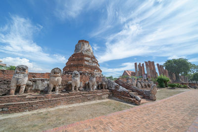 Statue of temple against cloudy sky