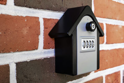 Close-up of telephone booth on wall