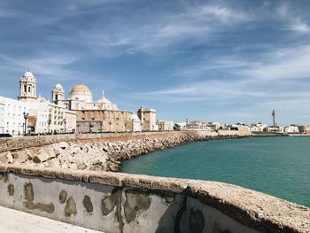 Historic building by sea against sky