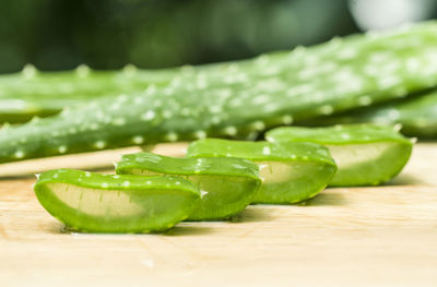 Close-up of green chili peppers on cutting board
