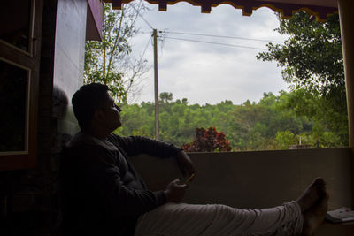 Man relaxing by window