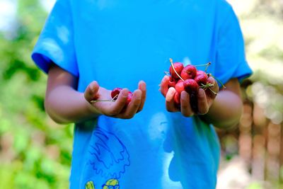 Midsection of man holding fruits