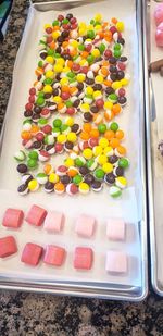 High angle view of multi colored candies in tray