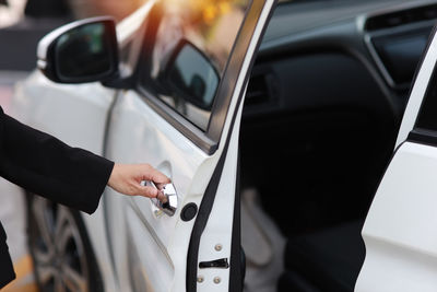 Midsection of man driving car